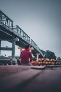 man sits near Bridge at river, indonesia, pontianak