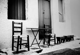 table with chairs on a narrow road near the building