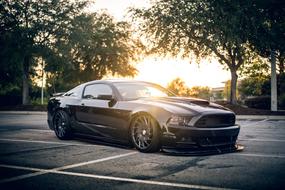 bright sun over a luxury car on the road