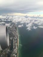 turbine of Plane Engine over aerial view of coastline