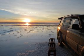 car on the coast in the water at dusk