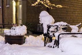 Snow Covered Bicycle on street