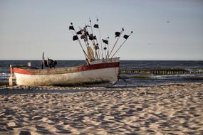 old fishing boat on beach at sea, poland