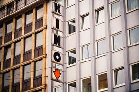 Old 'Cinema" sign on the building with windows, in the city