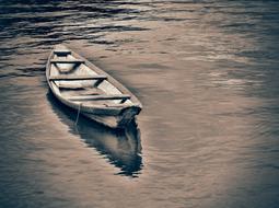 sepia, wooden fishing boat on the water