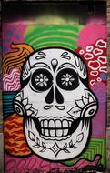 Colorful graffiti with the sugar skull, among the patterns, on the wall