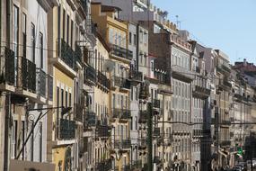 Colorful houses in sunlight, in Lisbon, Portugal, under the blue sky