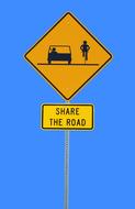 Orange and black "Share the road" road sign, at blue background, clipart