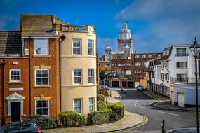 Beautiful and colorful buildings and plants on the streets in Portsmouth, England, under the blue sky with clouds