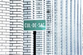 White building and Cul-De-Sac Street Sign