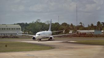 Landscape with the "Boeing 737" aircraft on the field, near the trees