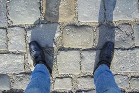 Man Shoes Boots on paving stones