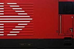 Close-up of the red locomotive train with white arrow