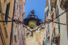 chains and antique lamp on the street in Venice