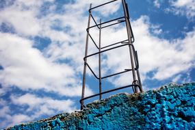 metal construction against cloudy sky