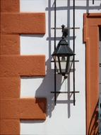 shadow from a street lamp on the wall of a building