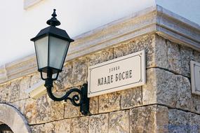 street lamp and sign with the street name mlada bosna, visegrad, bosnia