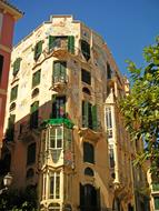 Beautiful corner house near the trees, in Majorca, Spain, under the blue sky