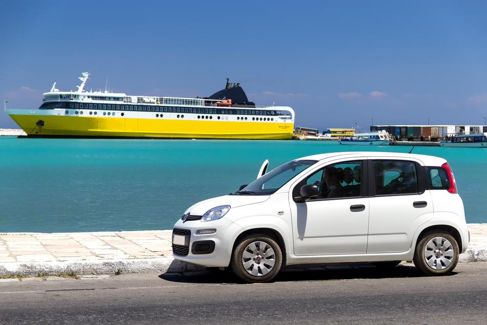 Beautiful landscape with the white car and yellow and white ship of the turquoise water, in Zakynthos, Greece