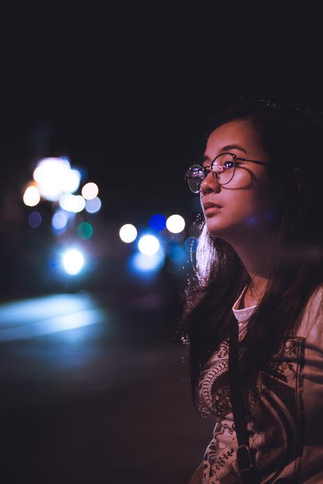 girl with glasses on the background of city traffic