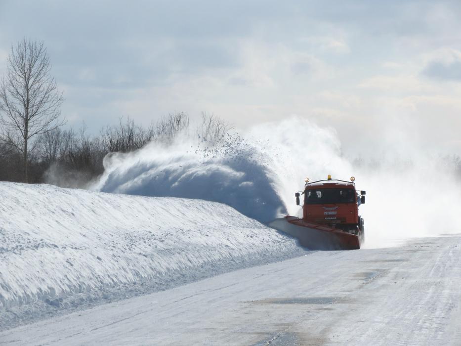 snowblower on the road on a sunny day