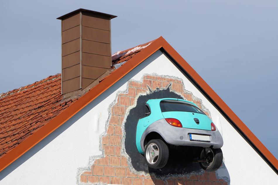turquoise car model in the roof of the house, at blue sky on background