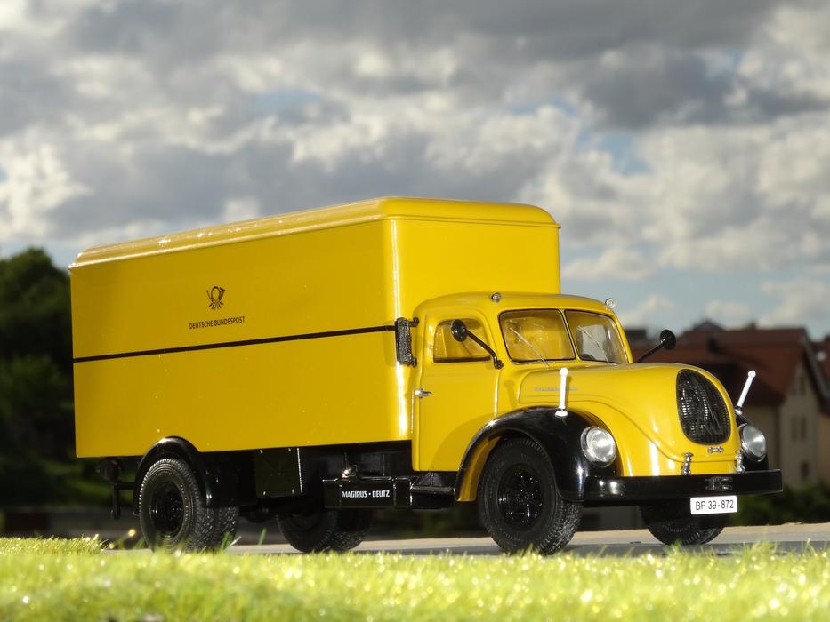 yellow mail truck on the road