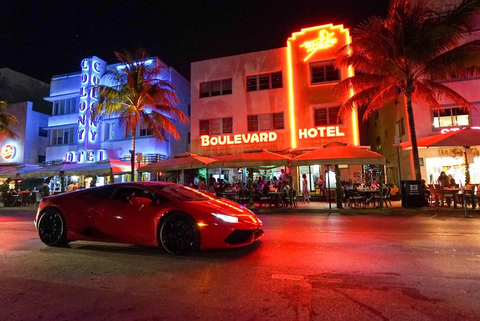 sports car and neon lights of hotels in Miami