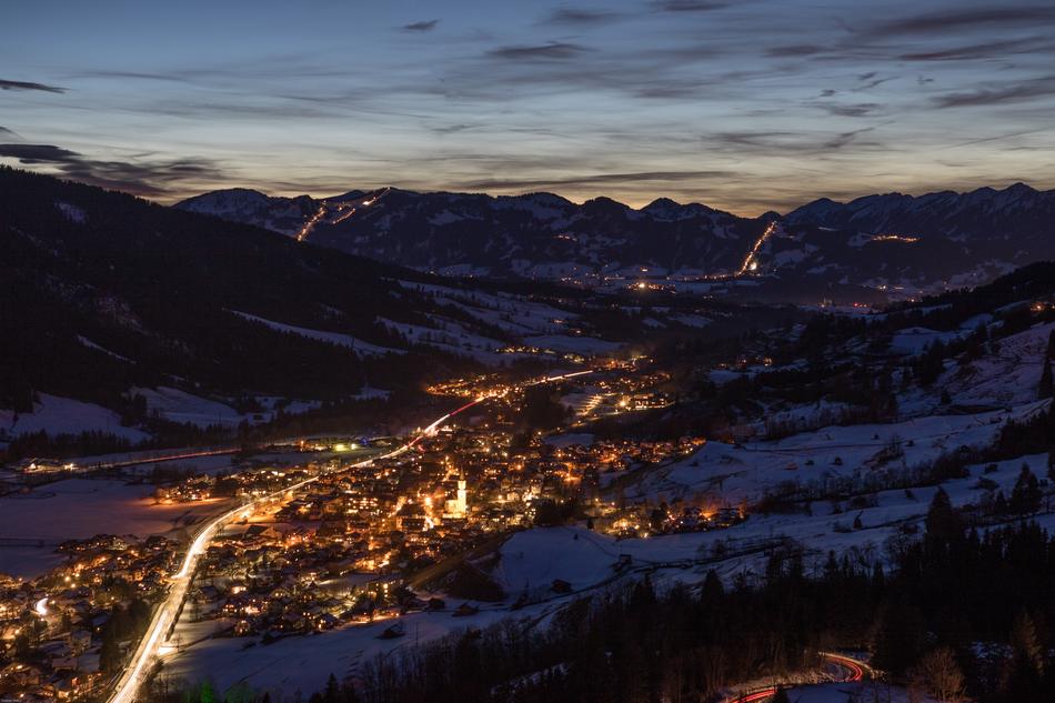 night photo of the city near the mountains
