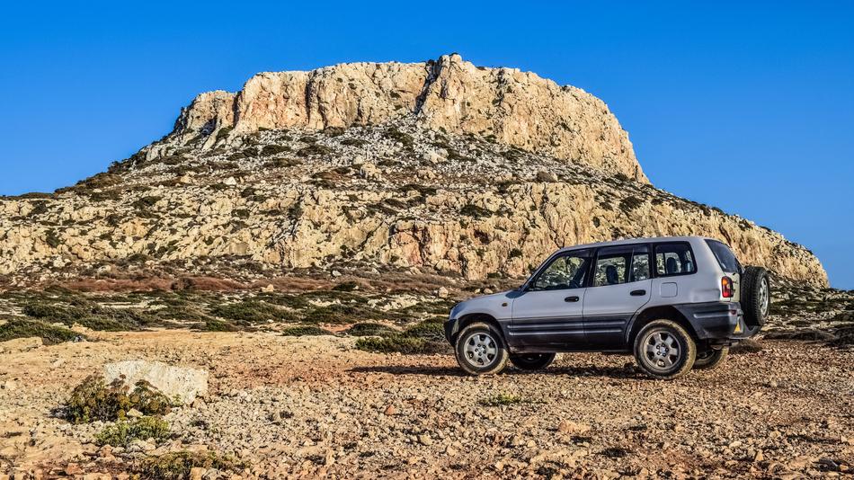 SUV near the cliff in the wild