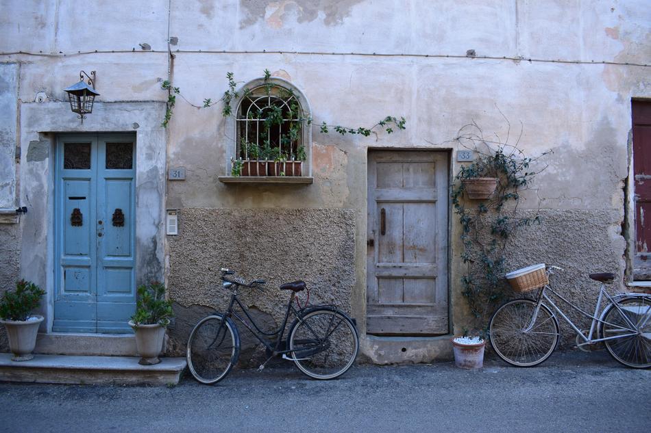 bicycles near the wall of an old house