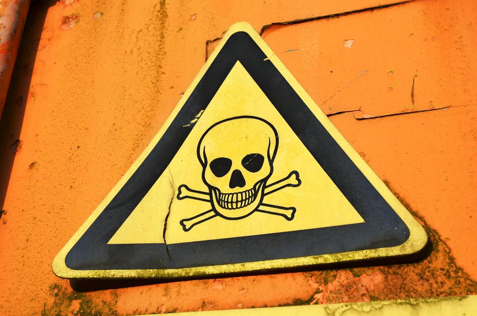 Warning Sign on a yellow wall close-up