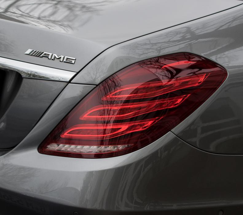 Close-up of the red backlight of the shiny, grey 'Mercedes Amg' car