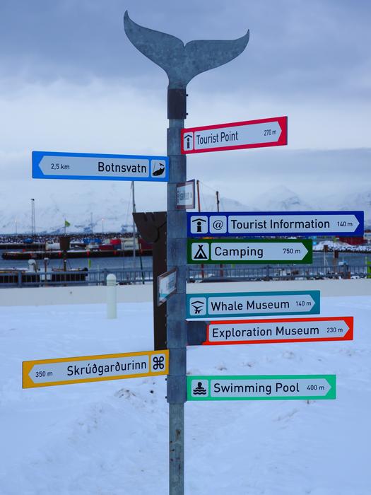 Colorful signposts, among the beautiful snow in Akureyri, Iceland