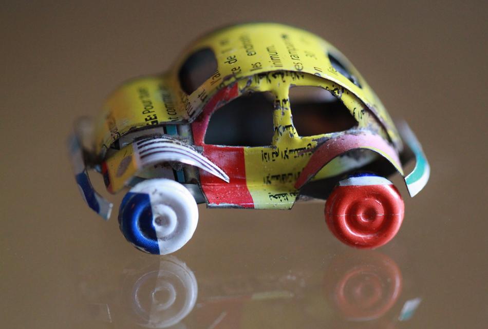 car as a tin toy on a mirror surface
