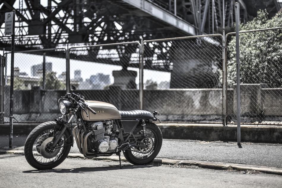 Landscape with the retro 'Honda' motorcycle under the bridge, near the fence