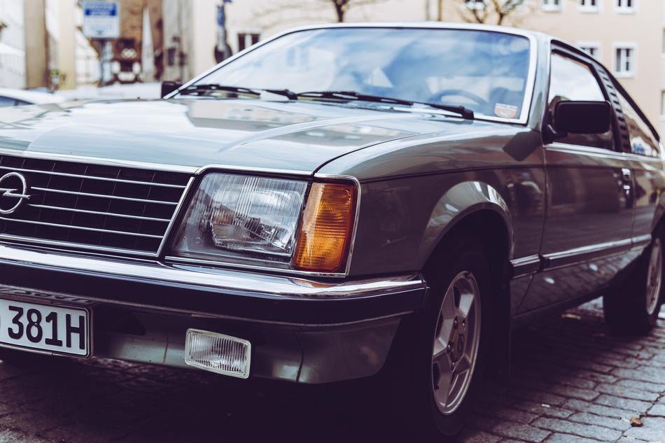 Beautiful, shiny, retro 'Opel Monza' car on the pavement, among the buildings
