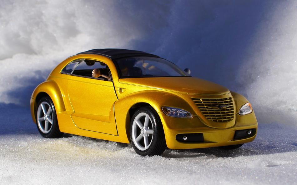 model of yellow car cruiser on a background of clouds