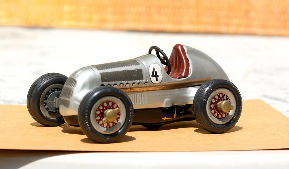 Shiny, metallic toy car with number 'four' in light