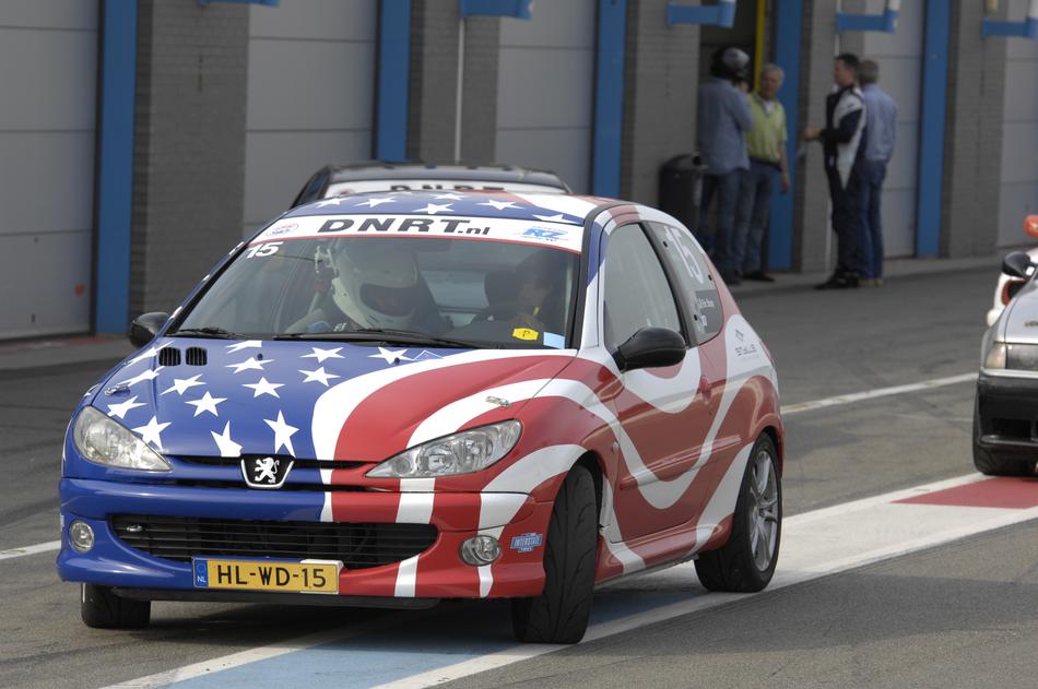 the car is painted in the color of the American flag on the road