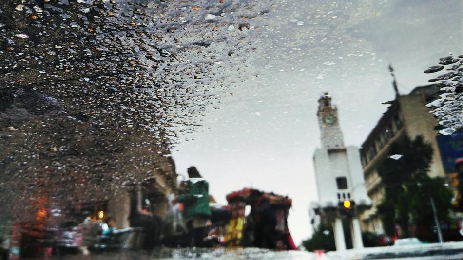 Street of China, with people, among the buildings, in water drops