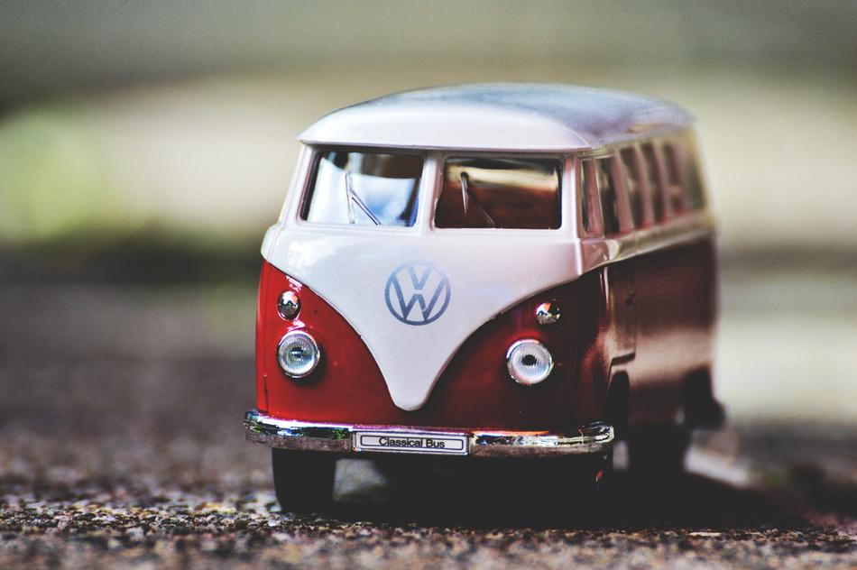 Shiny model of the red and white 'VW' van, at blurred background