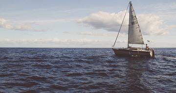 man on a sailing ship on the horizon