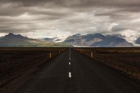 Road between Fields and Mountain