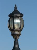 vintage black street lamp and blue sky