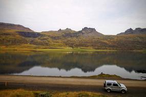 car passing by the lake