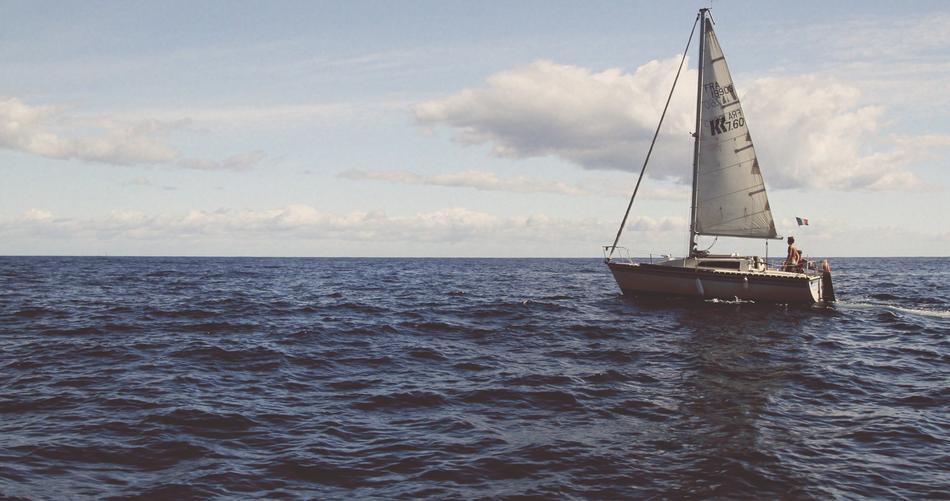 man on a sailing ship on the horizon