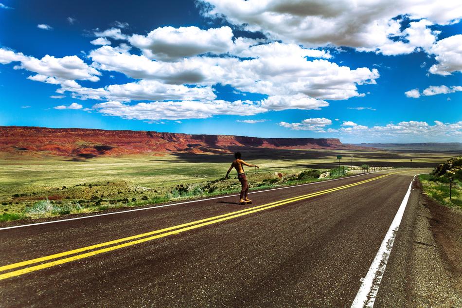 Skateboarder on Rural Road