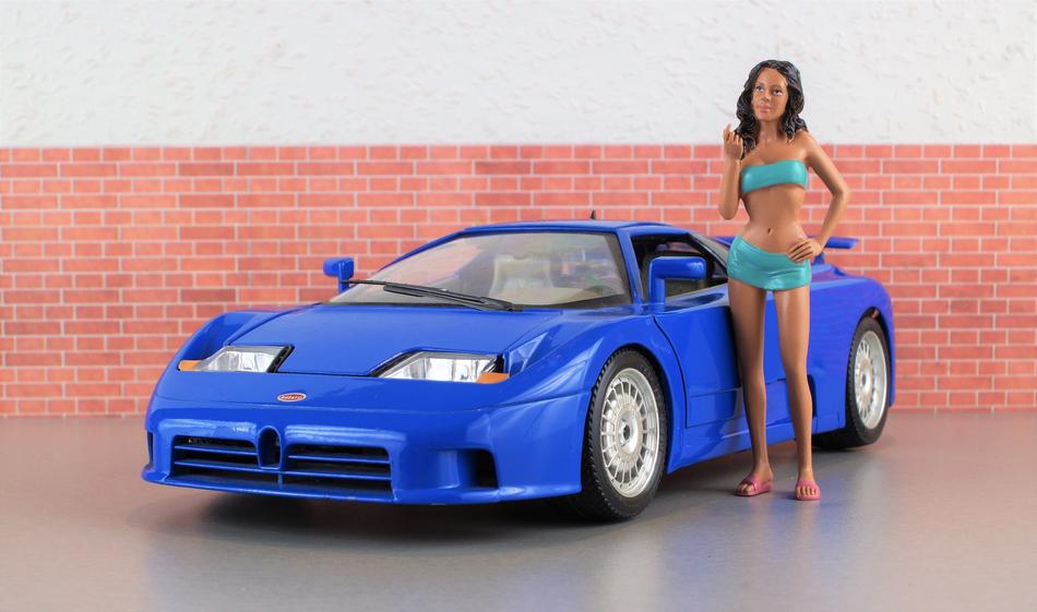 doll and blue toy bugatti car