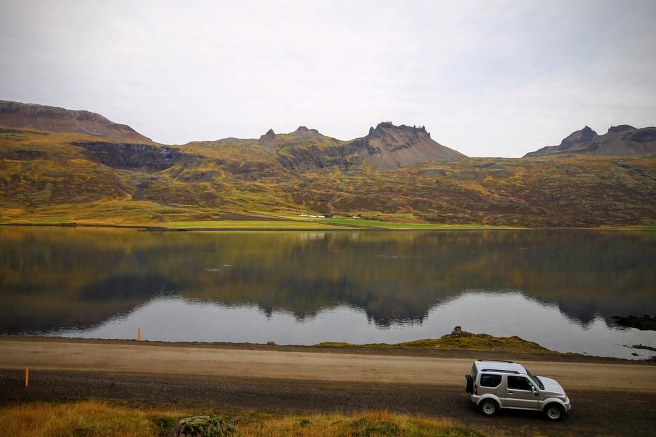 car passing by the lake